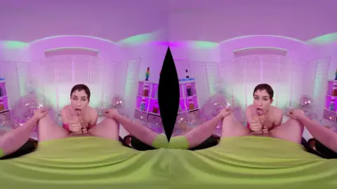 Slim brunette with piercings jerking off in neon-lit bedroom VR