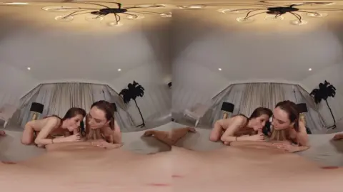 Two slim white girls eating each other out in bed with soft lighting