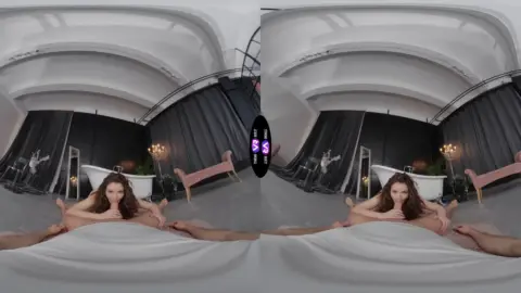 Brunette solo spread eagle on bed with hands on stomach