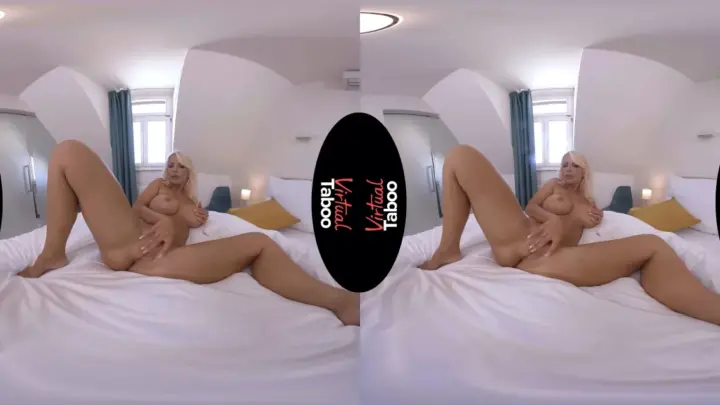 Blonde MILF spreads out on white sheets with candles burning