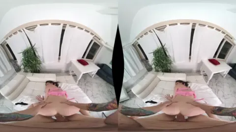 Slim brunette with leg tattoos spreads out on bedroom floor, natural l