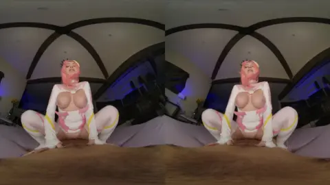 Pink-dressed curvy white girl on her knees in blue-lit event space