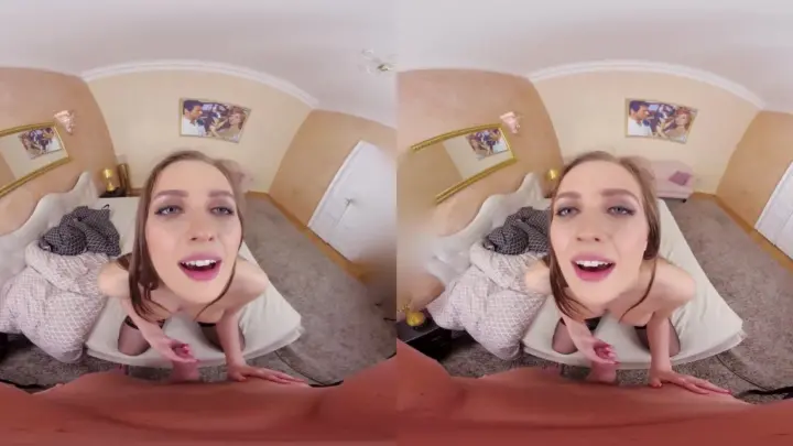 Blonde in black lingerie spreads out on bed with white wings