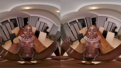 Black curvy girl with tattoos spreads out on living room floor