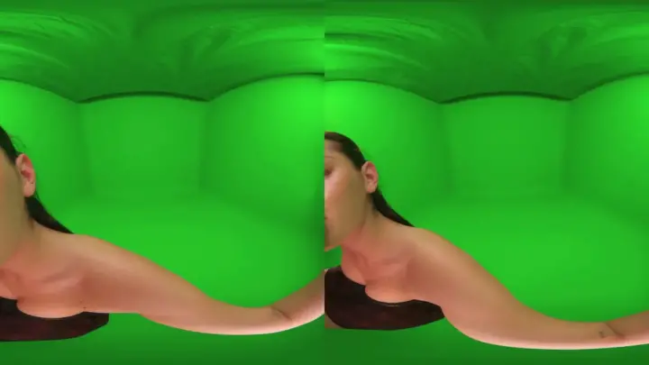 Thick brunette with pierced nipples spreads out on green screen