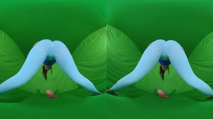 Brunette yoga girl in green fabric does intimate stretches on studio f