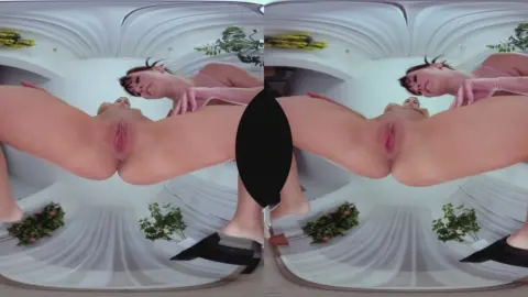 Brunette with arm tattoos spreads for camera in VR yoga pose