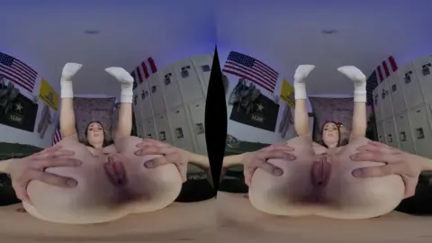 Slim brunette gives blowjob in locker room with American flags