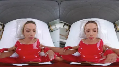 Blonde MILF in red latex spreads hard on bedroom floor