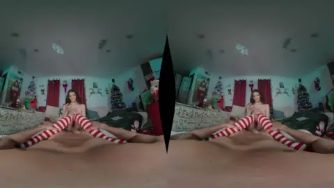 Petite brunette with torso tattoo spreads wide in Christmas-lit bedroo