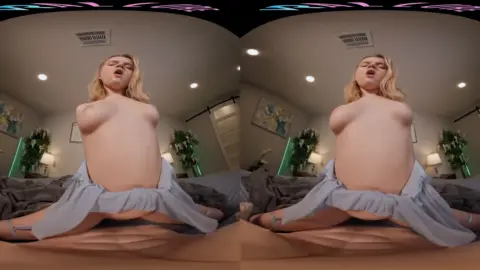 Blonde spreads legs wide on bed, shows everything in warm lit room