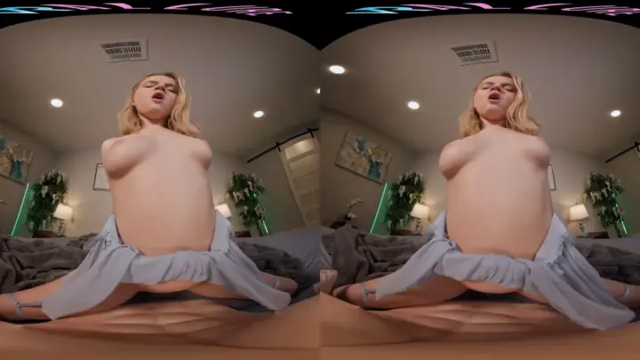 Blonde spreads legs wide on bed, shows everything in warm lit room