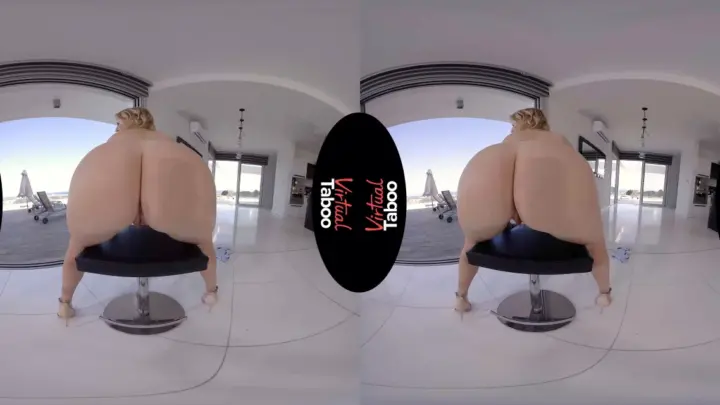 Blonde spreads wide on chair in bright modern room