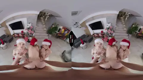Two blonde lesbians make out and get naked on couch under Christmas li
