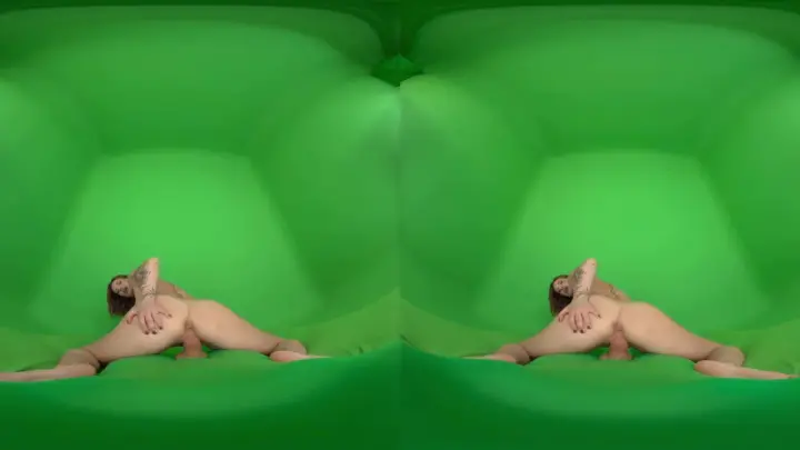 Curvy brunette with tattoos strips on green screen studio floor