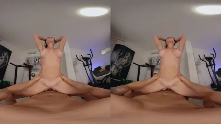 Brunette with tattoos spreads out on home gym equipment